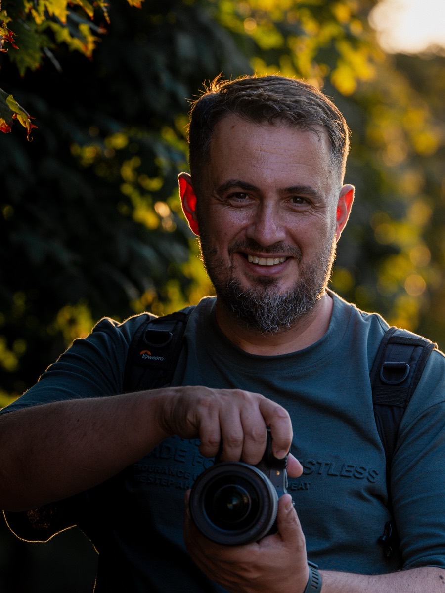 Fotograf cu aparatul în mână, la apus